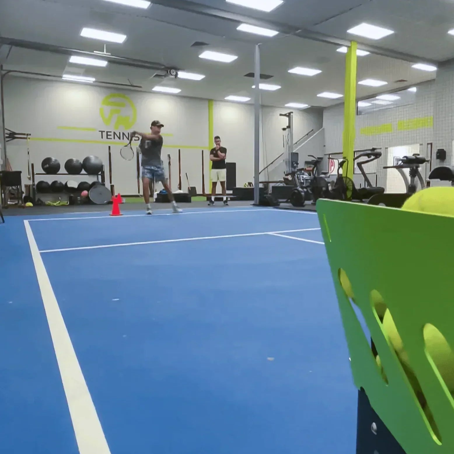 indoor tennis training with a ball machine