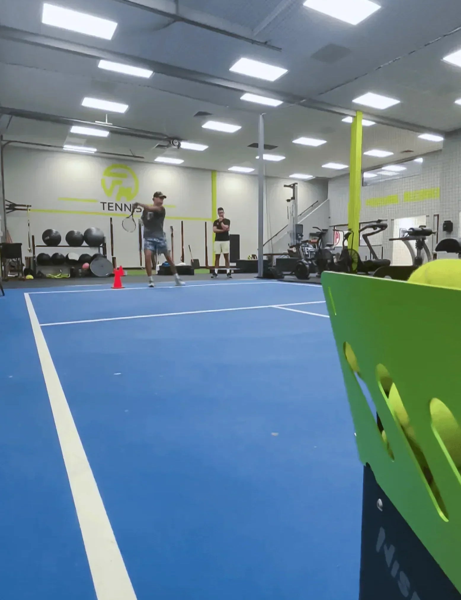 indoor tennis training with a ball machine