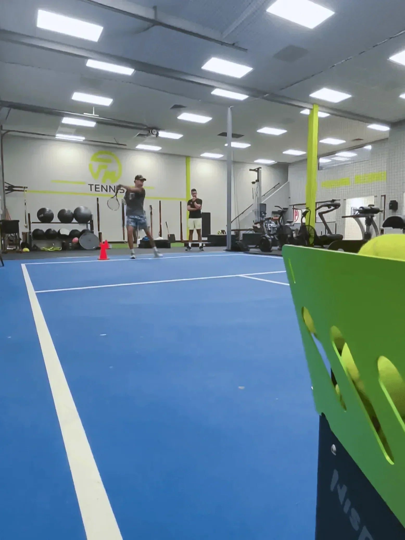 indoor tennis training with a ball machine