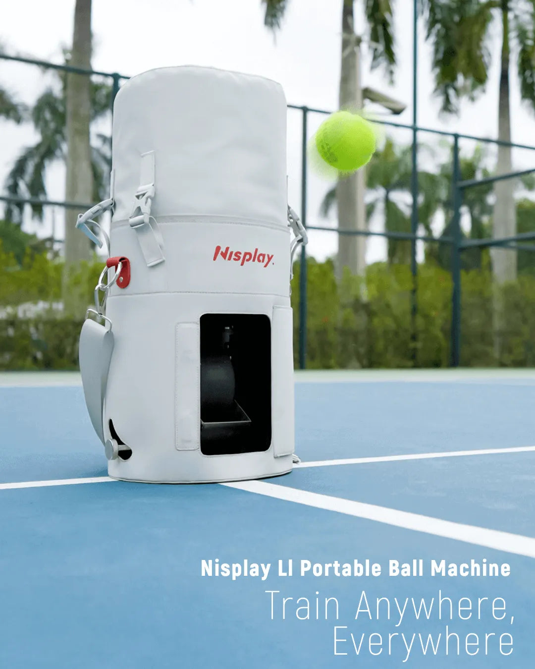Nisplay L1 portable ball machine on a tennis court with palm trees in the background
